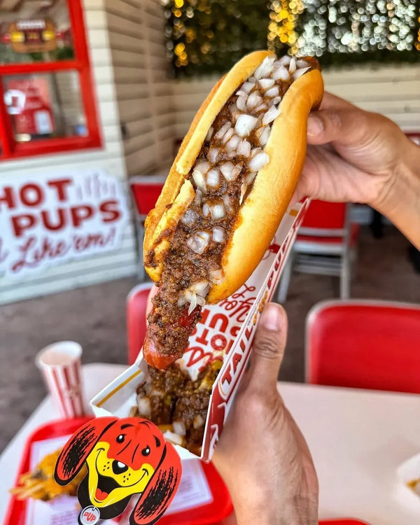 Tail O’ The Pup Chili Pup topped with meat chili and finely diced white onions.