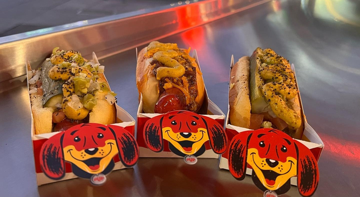 Local favorite hot dogs in Los Angeles at Tail O' The Pup, served in iconic pup-shaped trays.